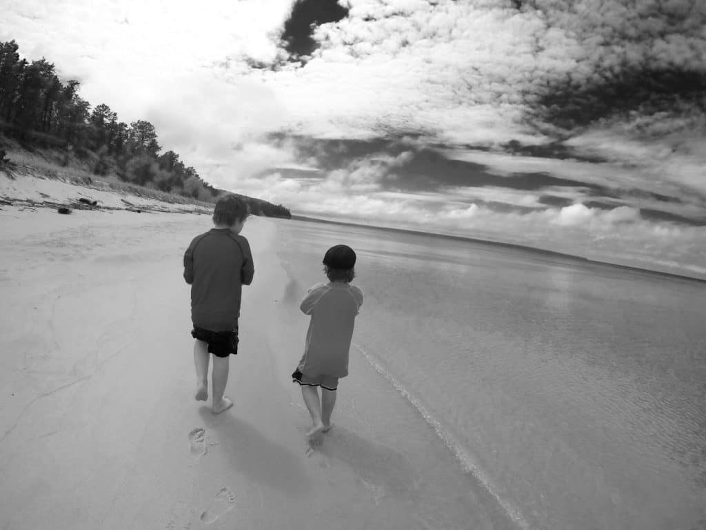 black and white photo of boys on Michigan beach