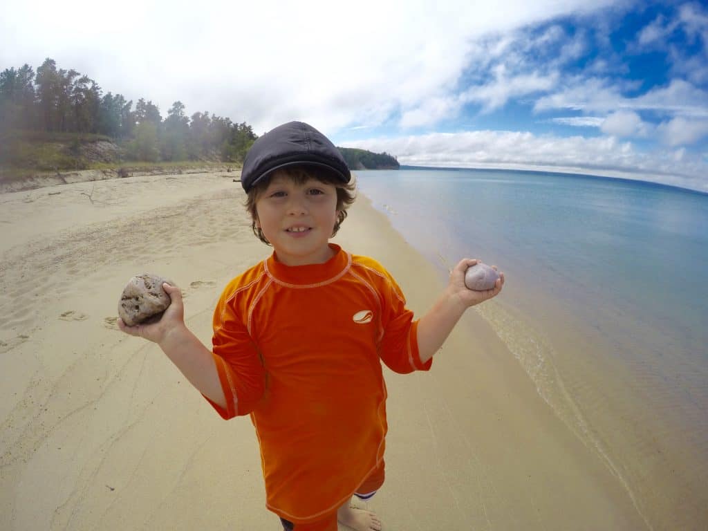 boy holding rocks at Pictured Rocks National Lakeshore