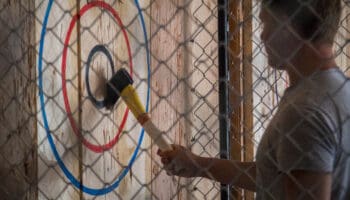 axe in bullseye on wood wall