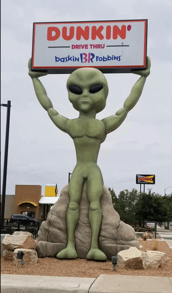 alien holding sign in Roswell