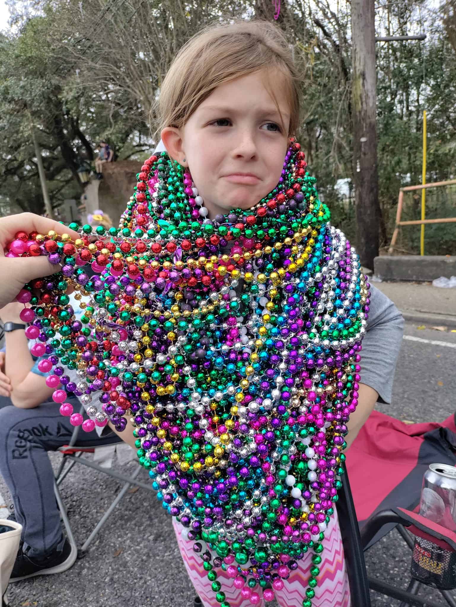 girl with beads at mardi gras