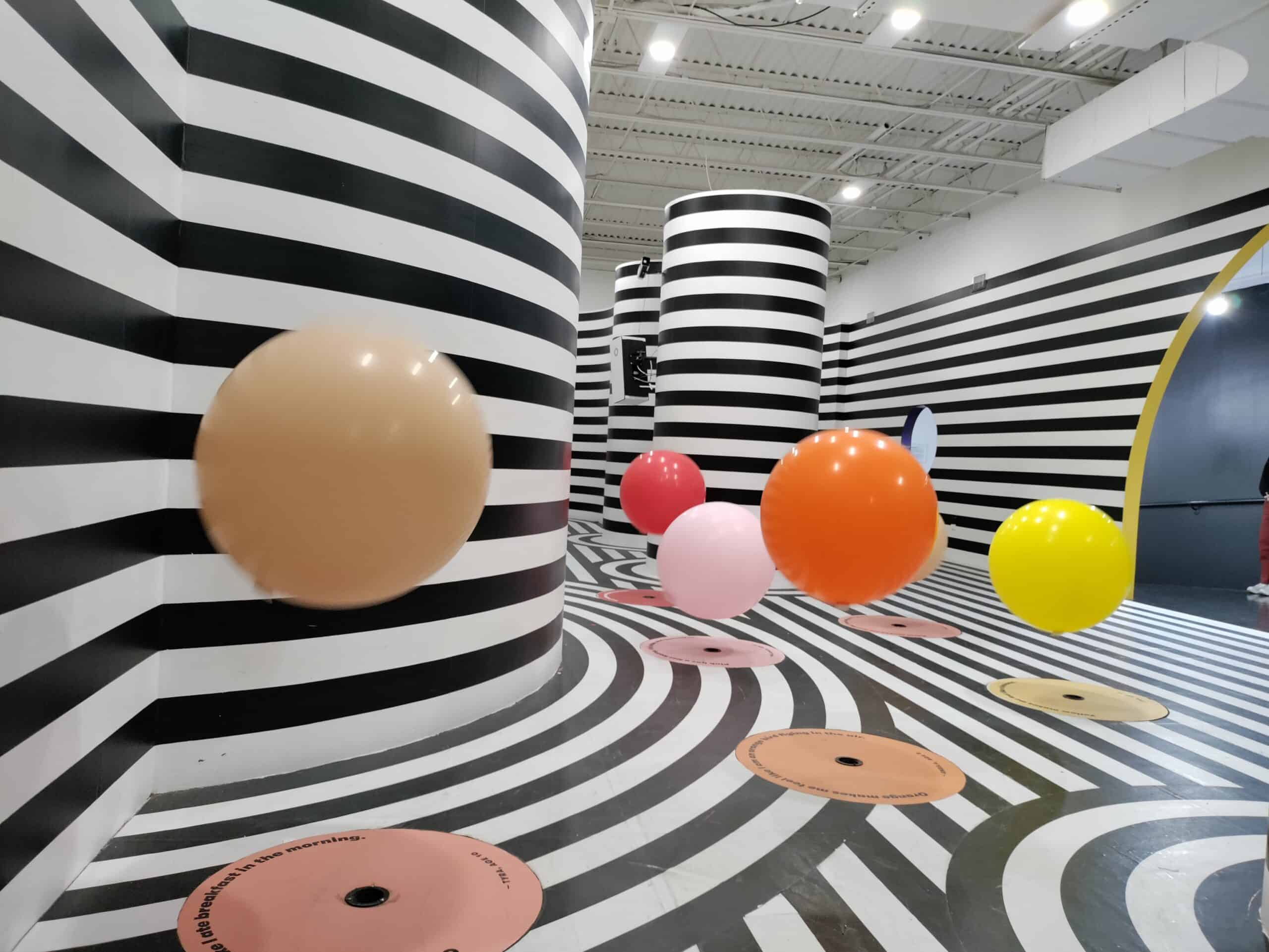 black white room with colorful balls Color Factory in Houston